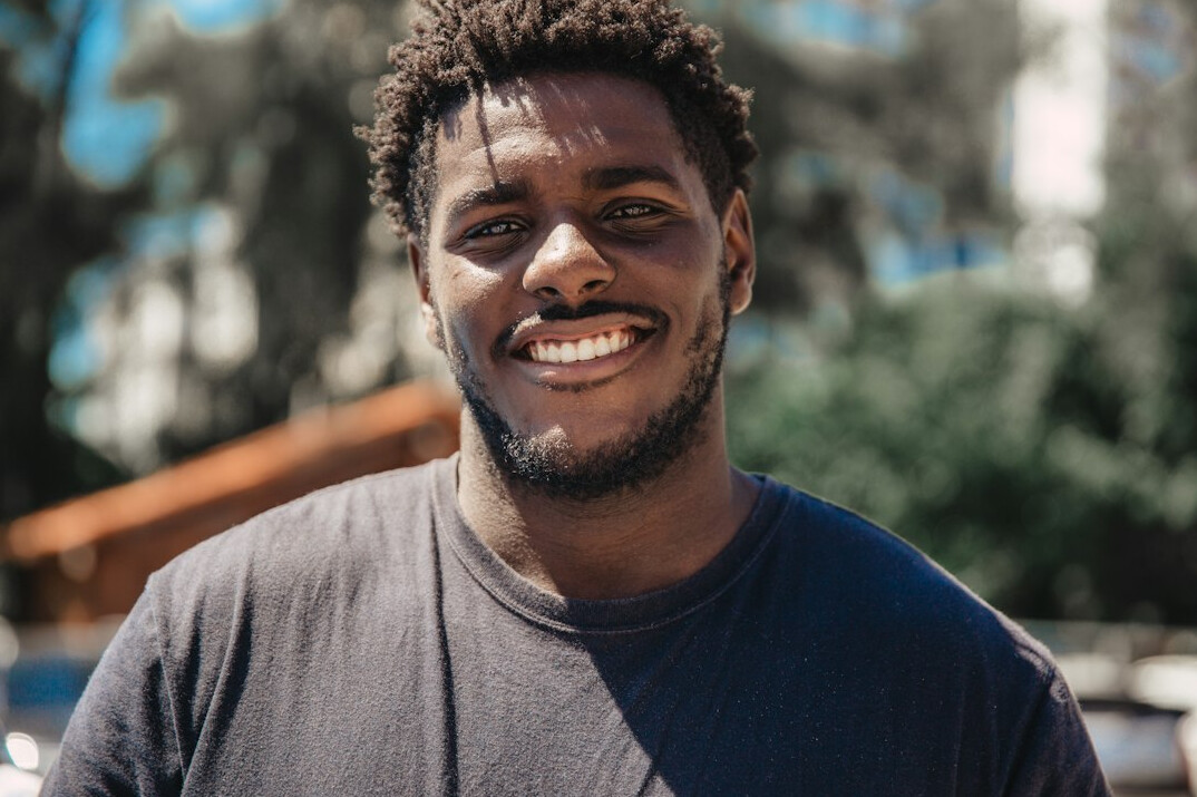 person smiling in sunlight