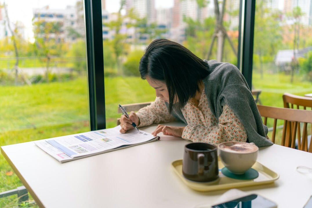 woman journaling at desk